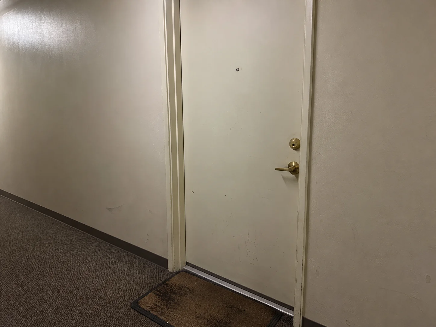 Apartment door deadbolt in a Koreatown Los Angeles building hallway